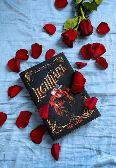 Book on fabric with rose petals