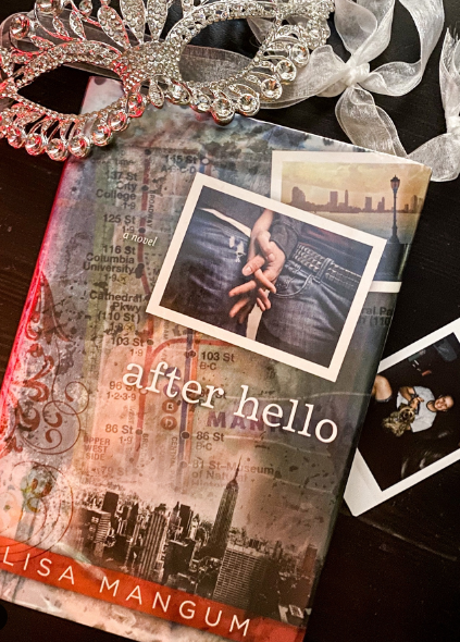 Book surrounded by masquerade mask and polaroid pictures