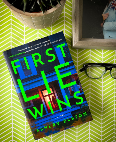 Book, glasses, and picture frame on green background