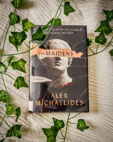 Book on white background draped in ivy