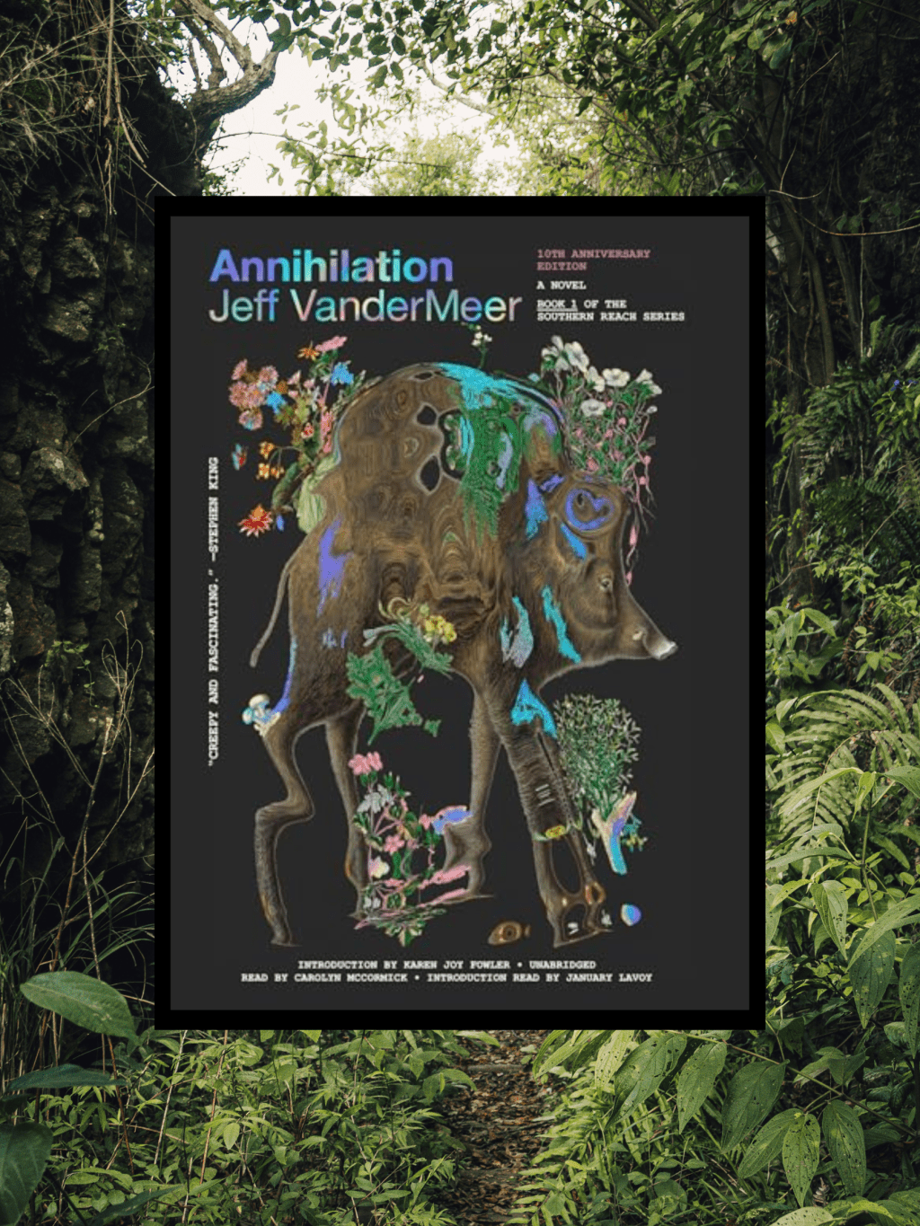 Book cover in front of green foliage