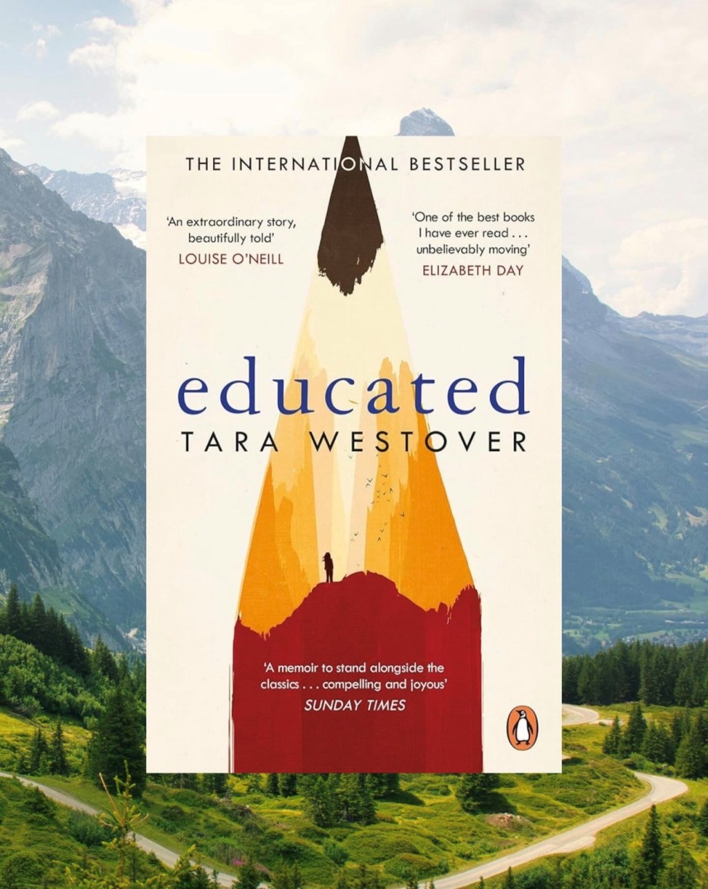 Book cover in front of mountain landscape photo